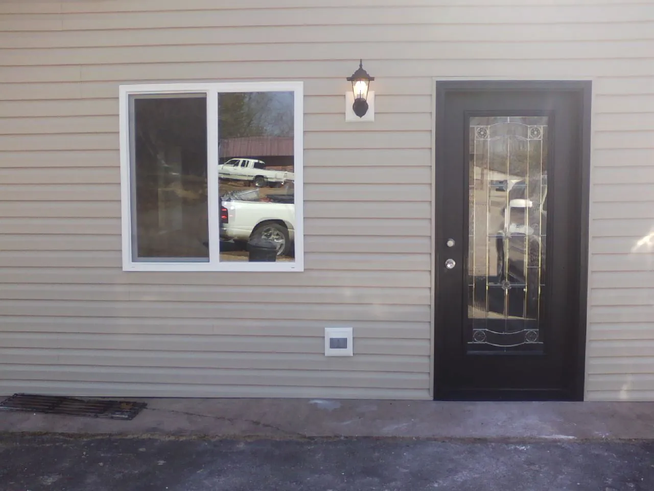 New siding, window and entry door on the side of an addition in Darrington